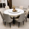 Elegant round marble dining set with six quilted cream chairs and gold trim